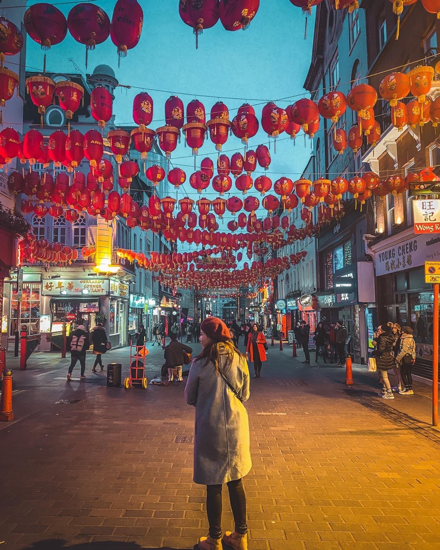 Yellow coat under chinatown lanterns at night