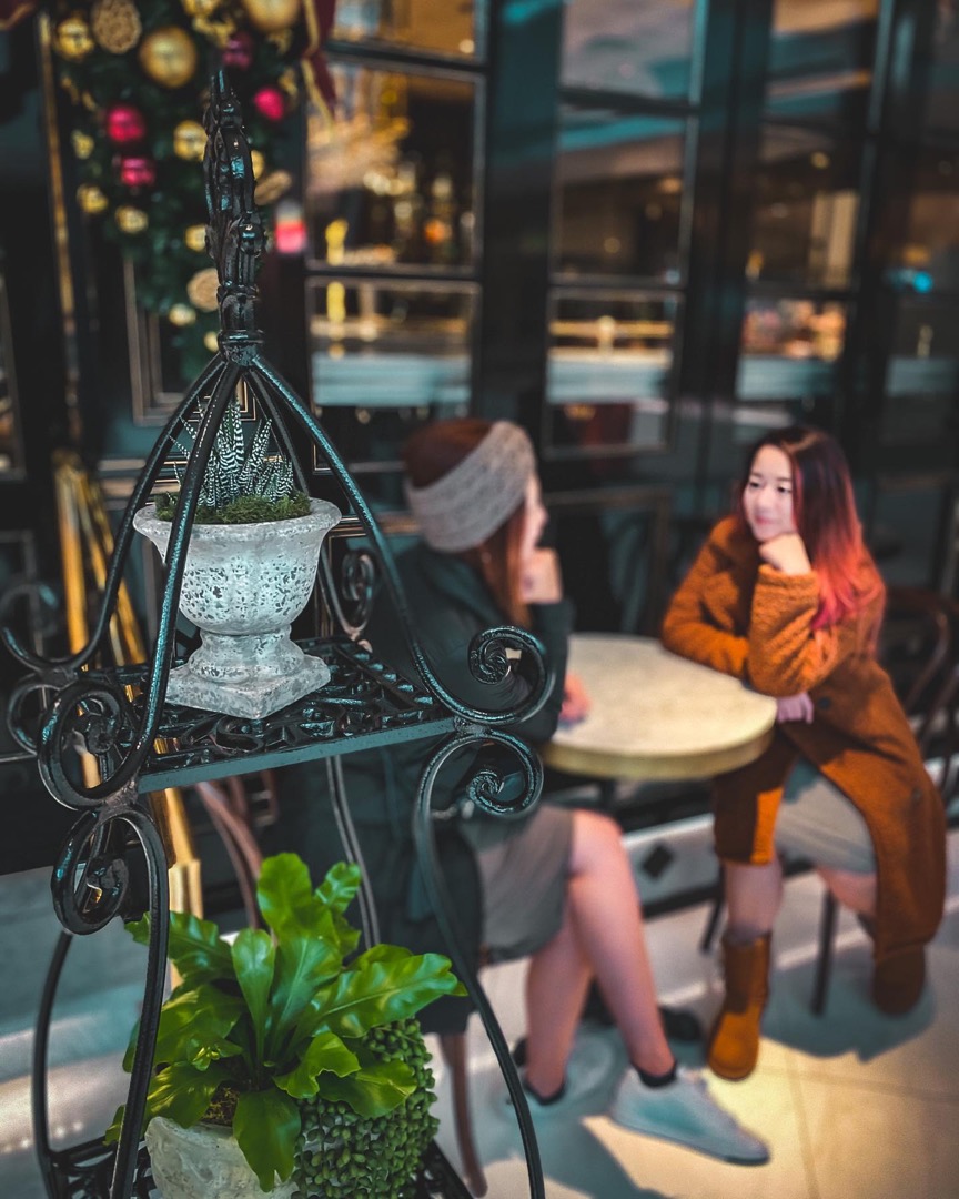 Couple at a table inside a conservatory cafe